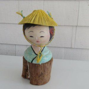 Kokeshi doll with yellow hat